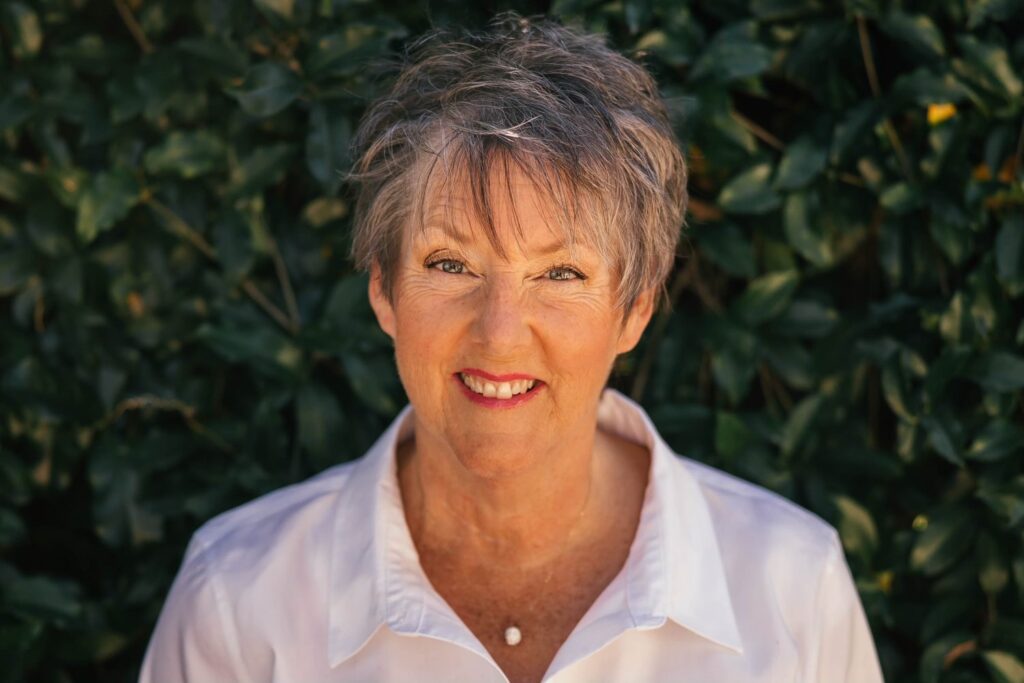 Smiling woman with short gray hair outdoors